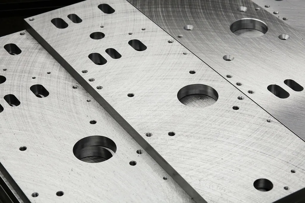 Freshly milled aluminum plates with pockets, slots and bored holes