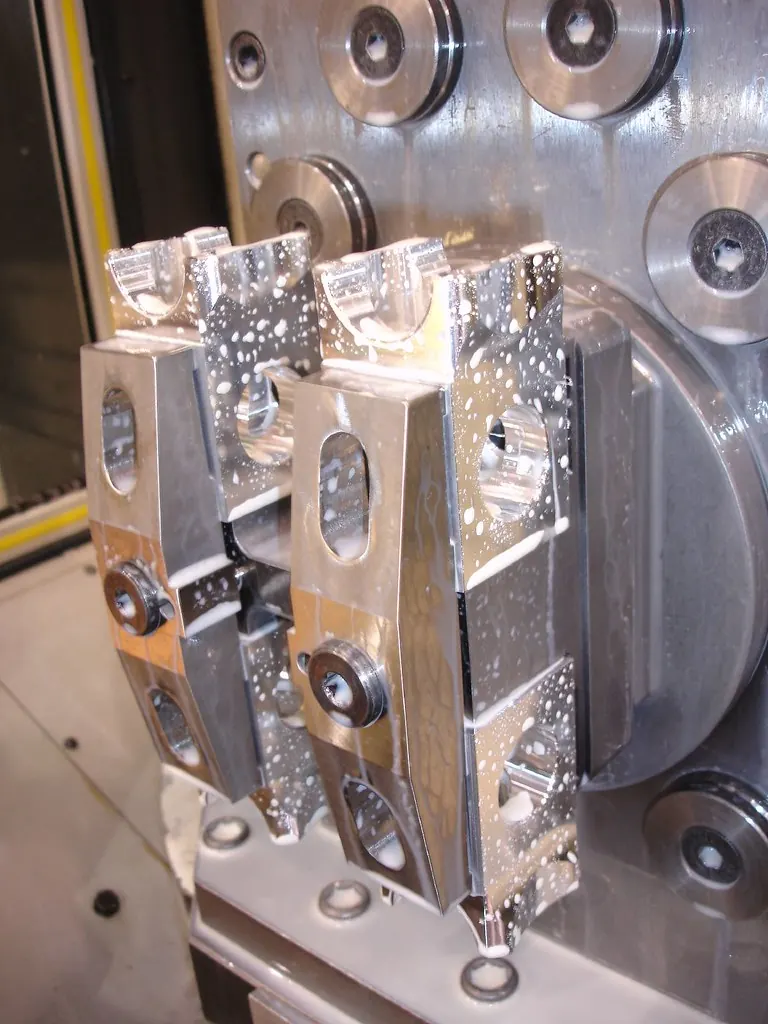 Small batch of machined aluminum parts fresh out of a CNC machine
