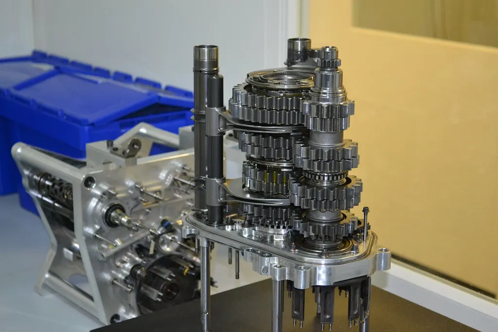 Precision gearbox components with shafts and gears laid out on a bench