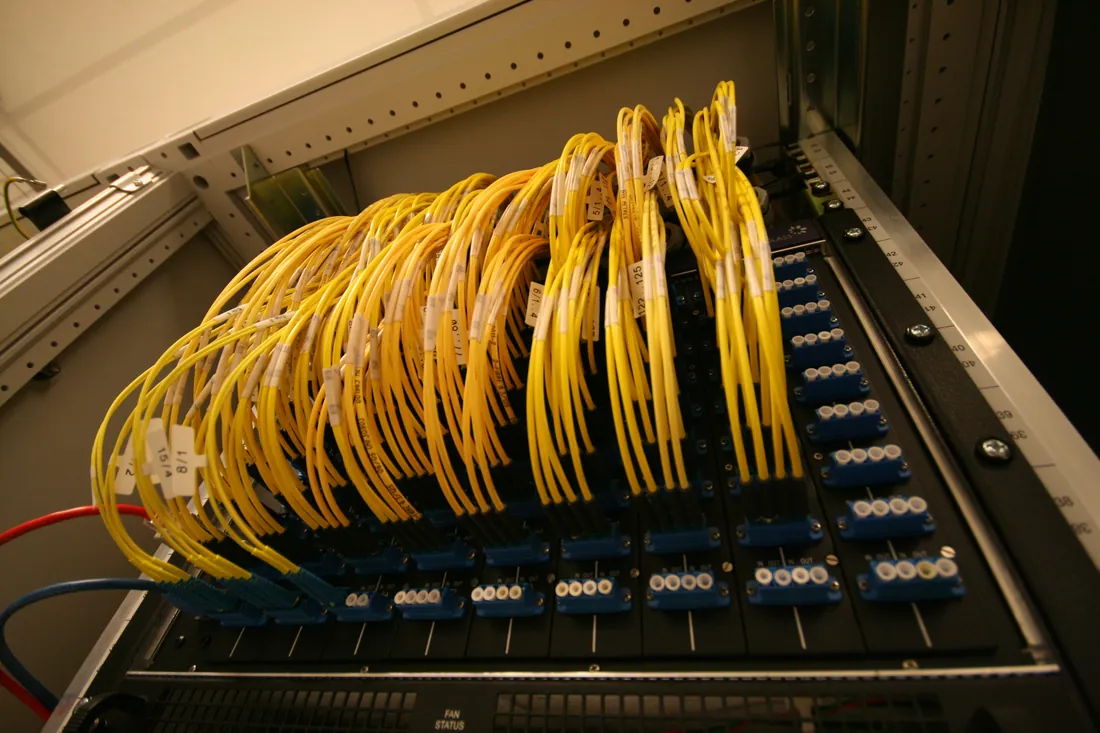 Neatly routed yellow network cables in a patch panel